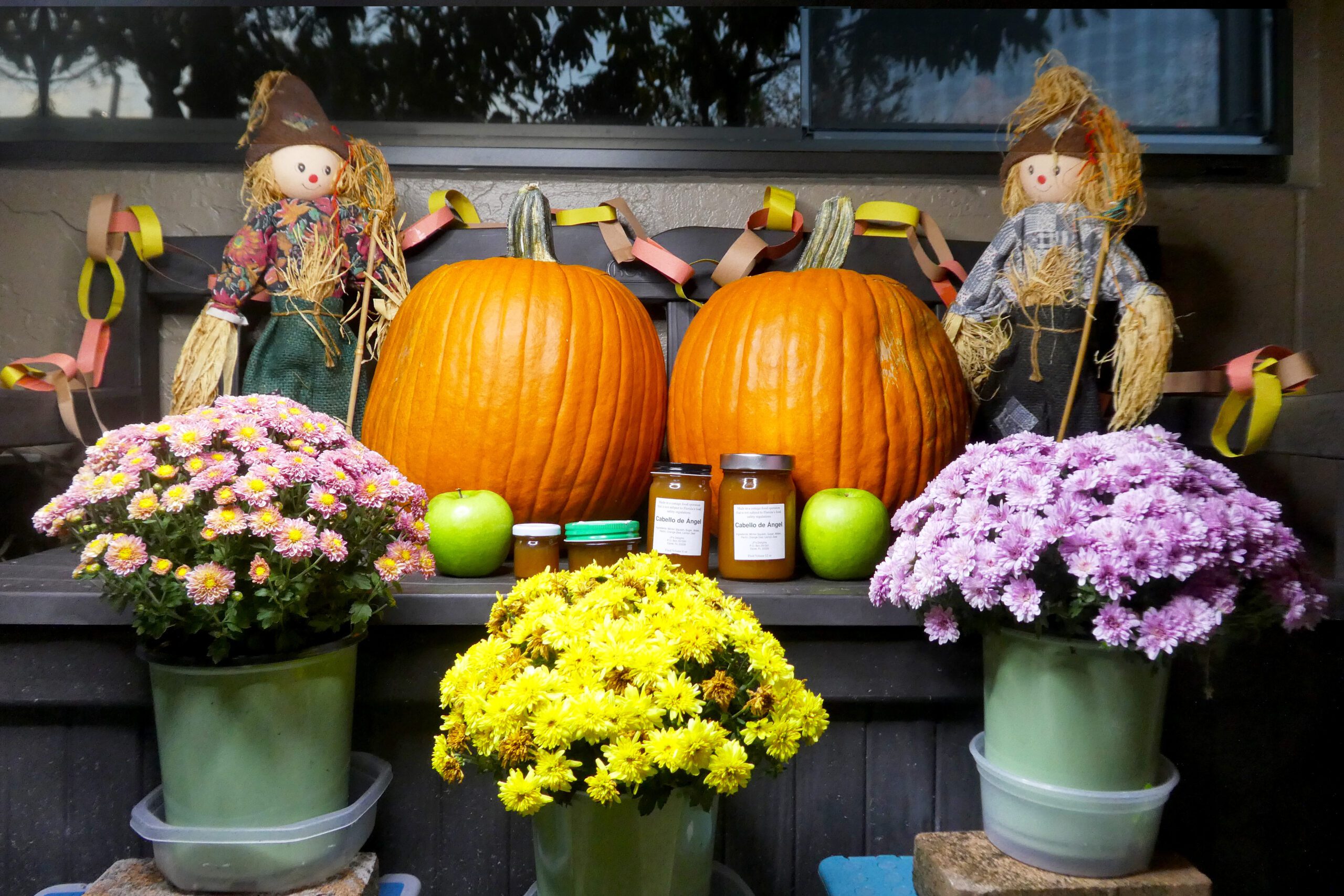 All size jars of Cabello de Angel in a fall setting, far shot