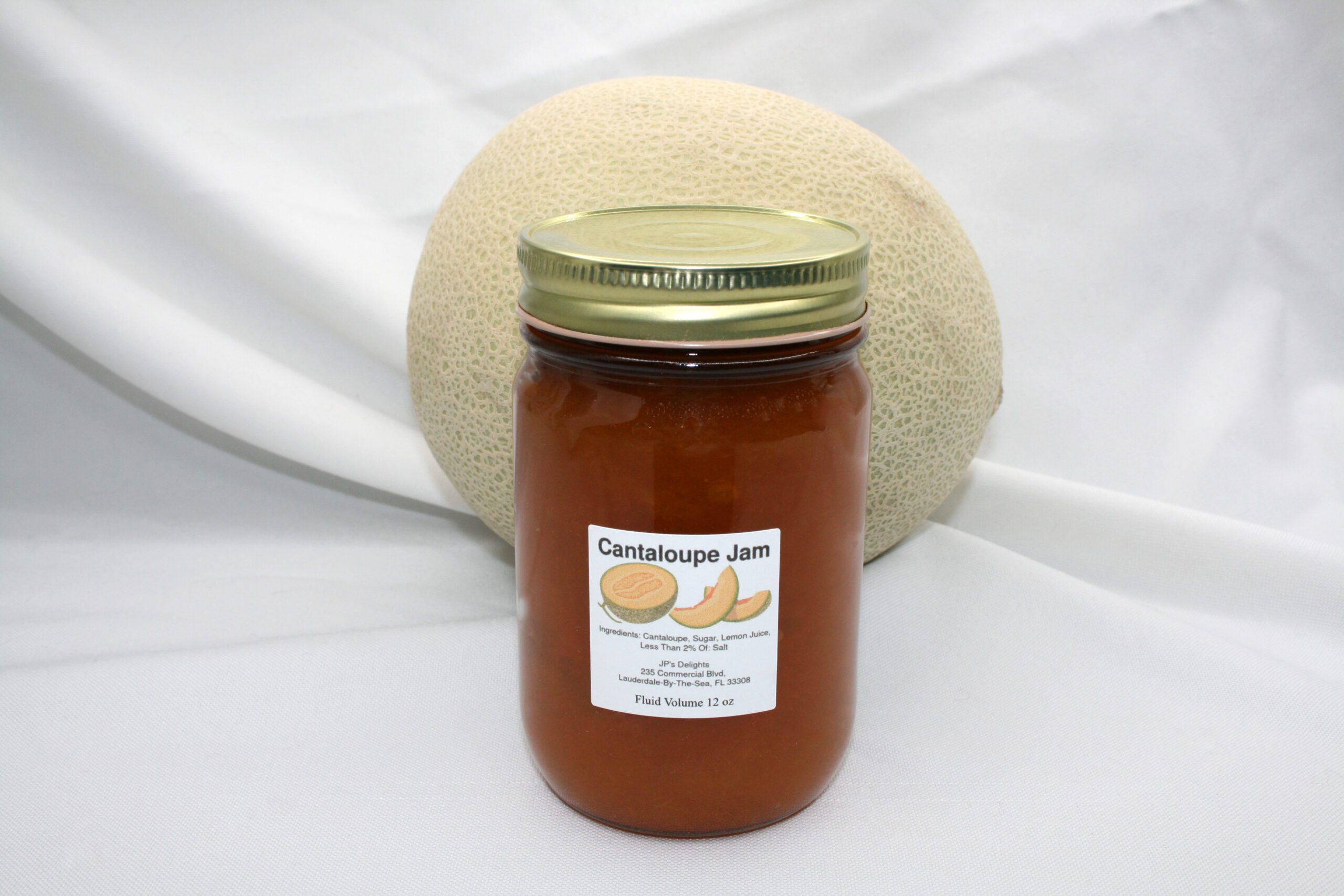 12 oz jar of Cantaloupe Jam surrounded by its ingredients