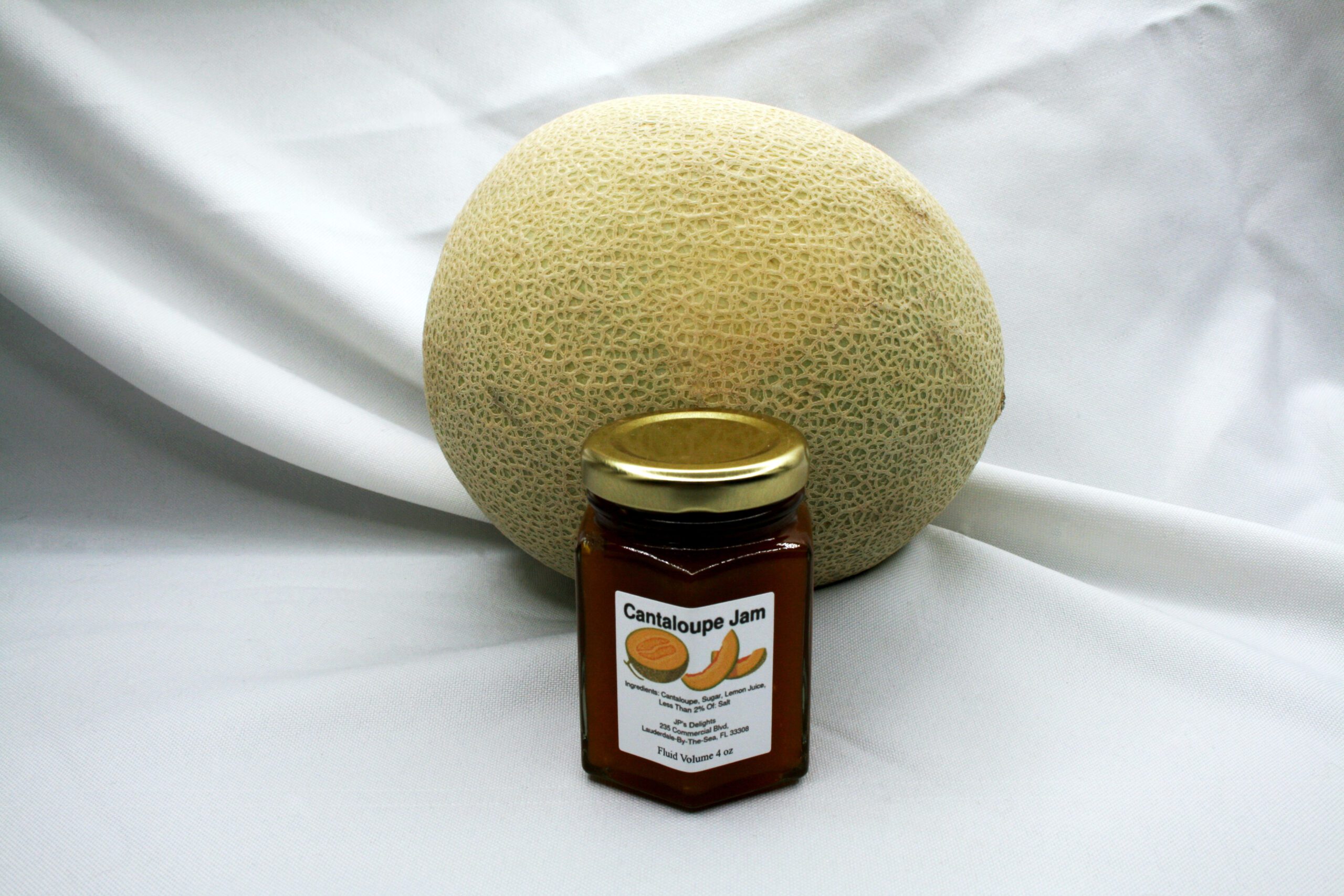 4 oz jar of Cantaloupe Jam surrounded by its ingredients