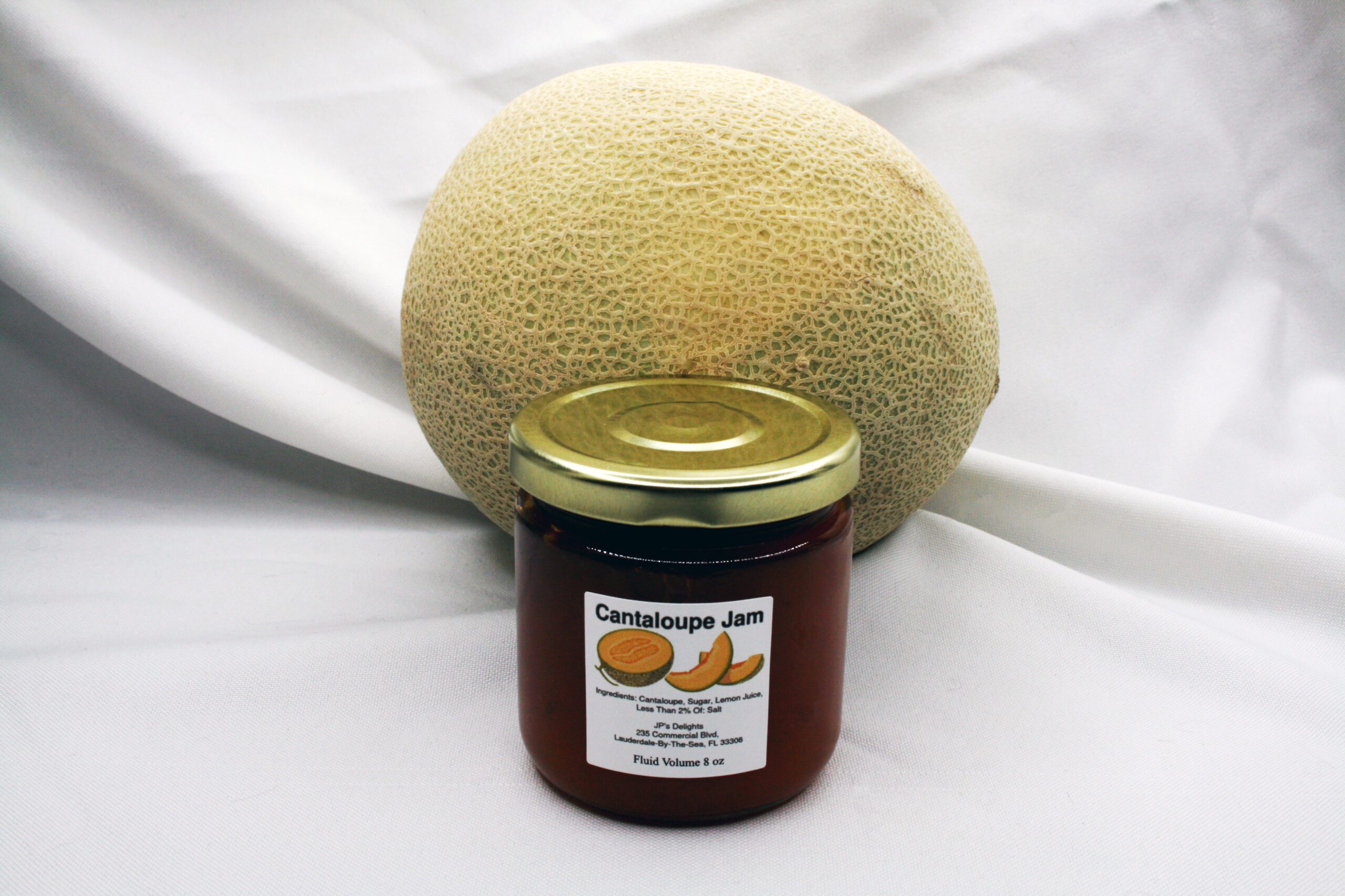 8 oz jar of Cantaloupe Jam surrounded by its ingredients