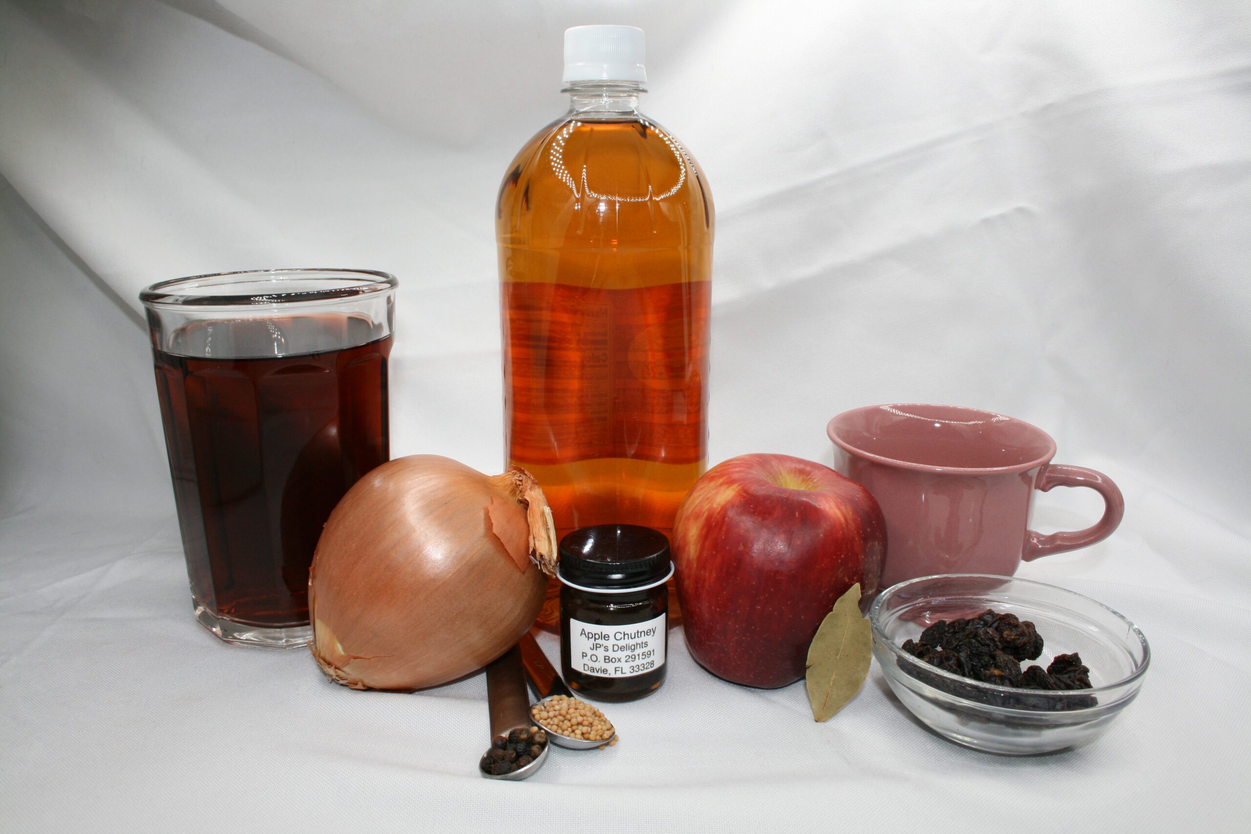 1.5 oz jar of Apple Chutney surrounded by ingredients in a far shot