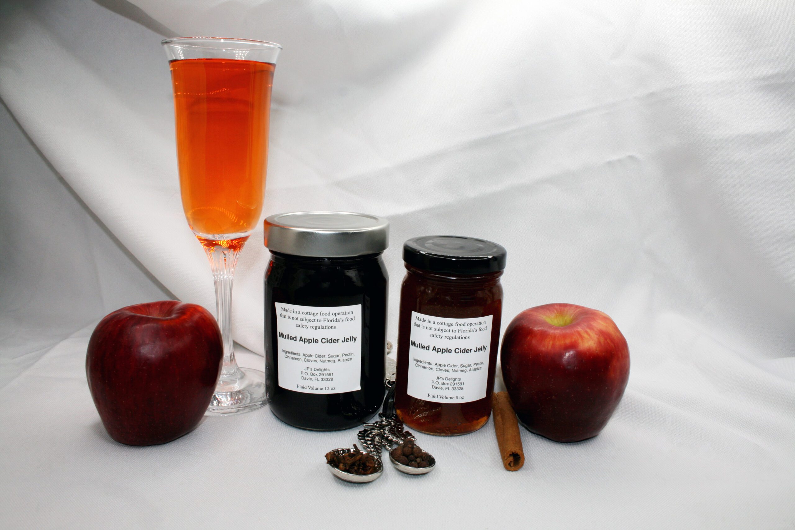 8 and 12 oz jars of Apple Cider Jelly surrounded by their ingredients