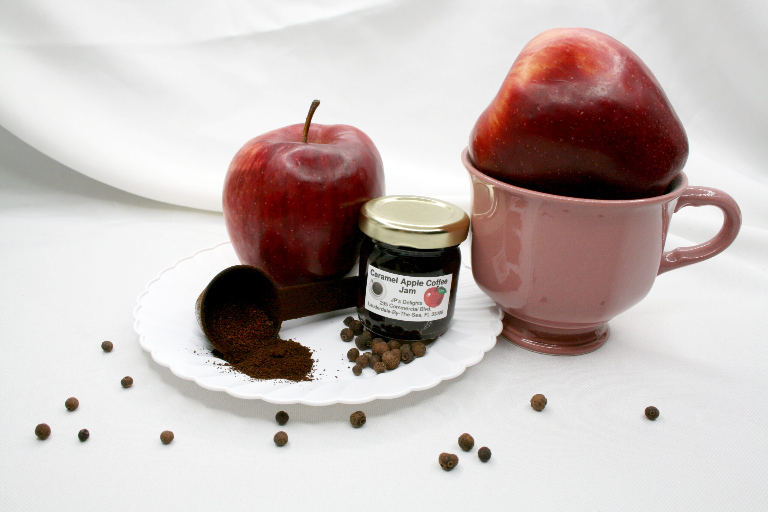 1.5 oz jar of Caramel Apple Coffee Jam surrounded by its ingredients