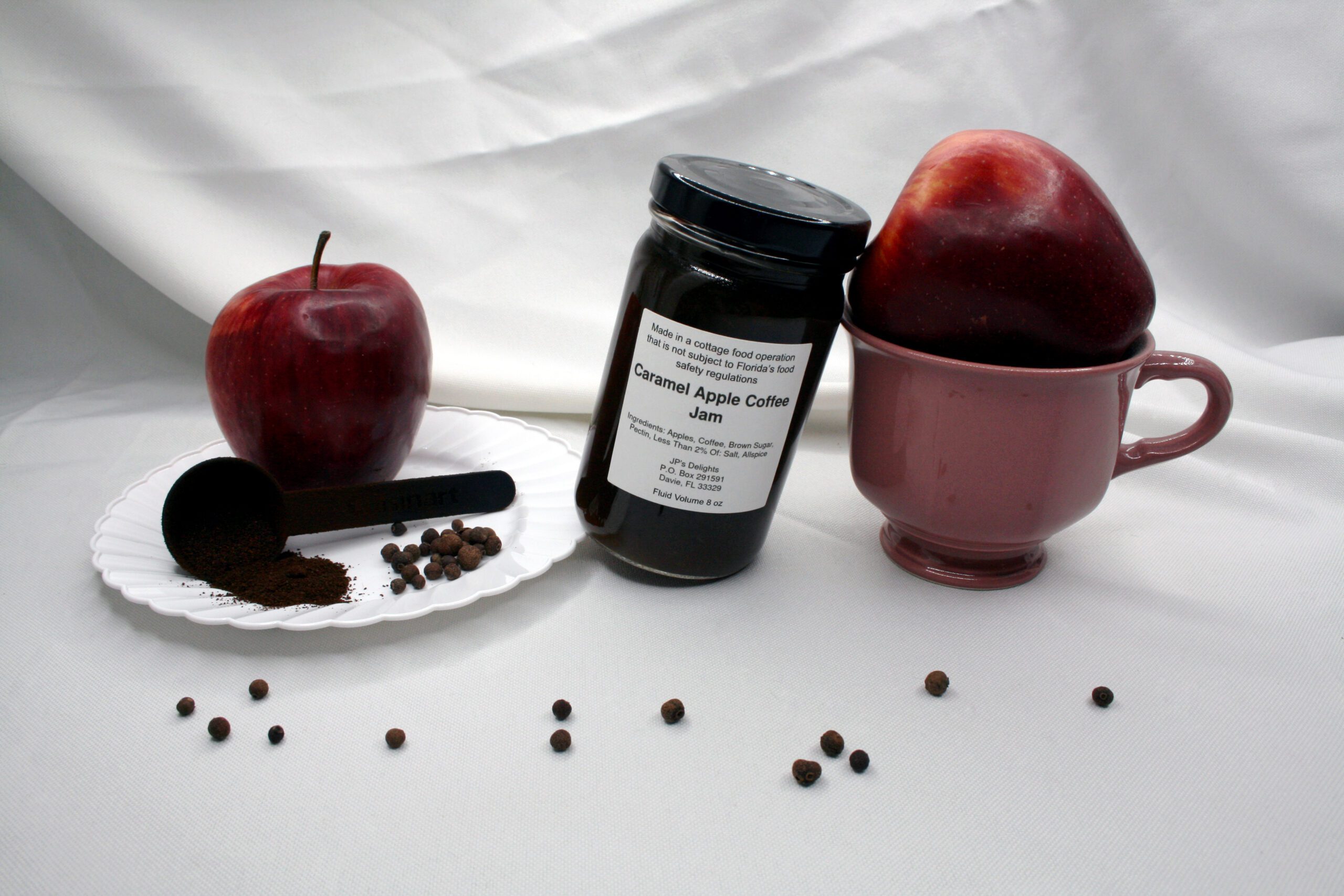 8 oz jar of Caramel Apple Coffee Jam surrounded by its ingredients